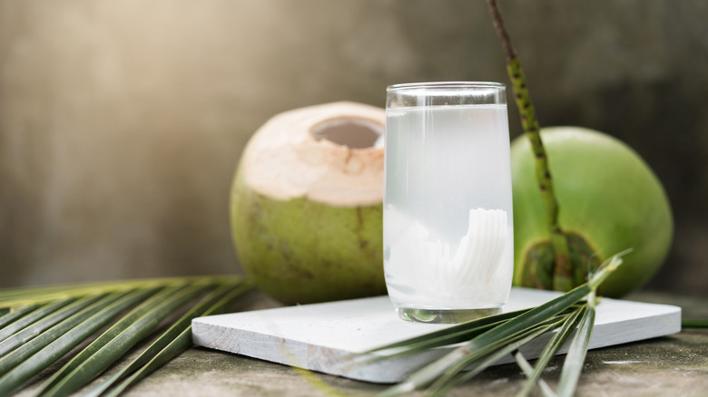 Coconut water next to coconut