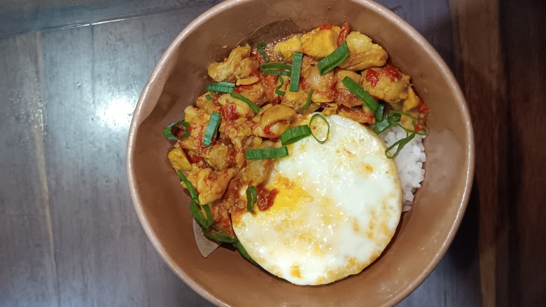 Indonesian dish with eggs over-easy