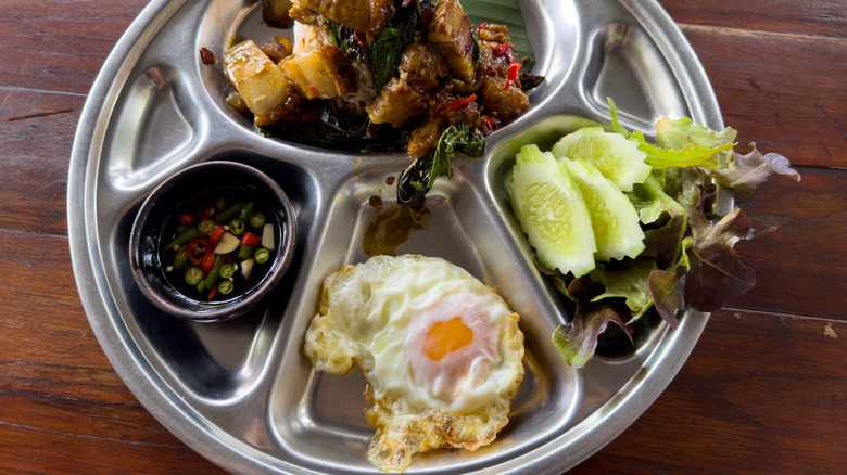 metal tray of dishes and crispy fried egg