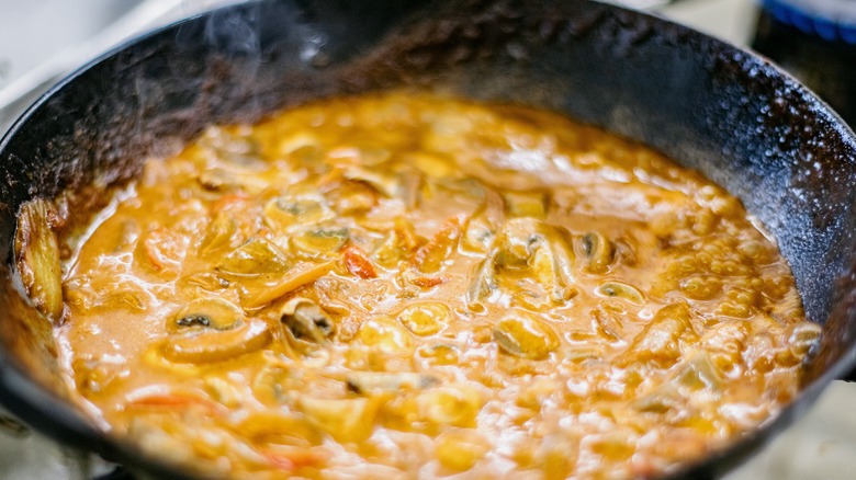 simmering mushrooms in a sauce