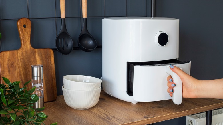 person using air fryer