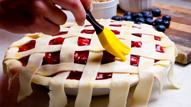 brushing wash on top of pie