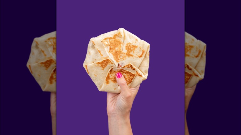 Crunchwrap Supreme from Taco Bell against purple background