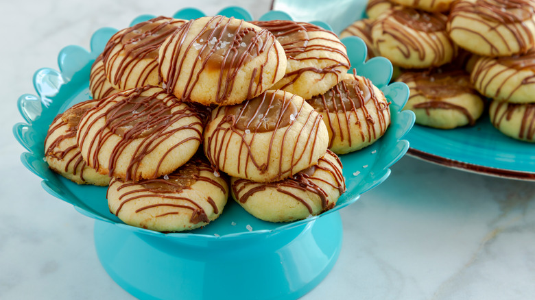 caramel thumbprint cookies on a stand