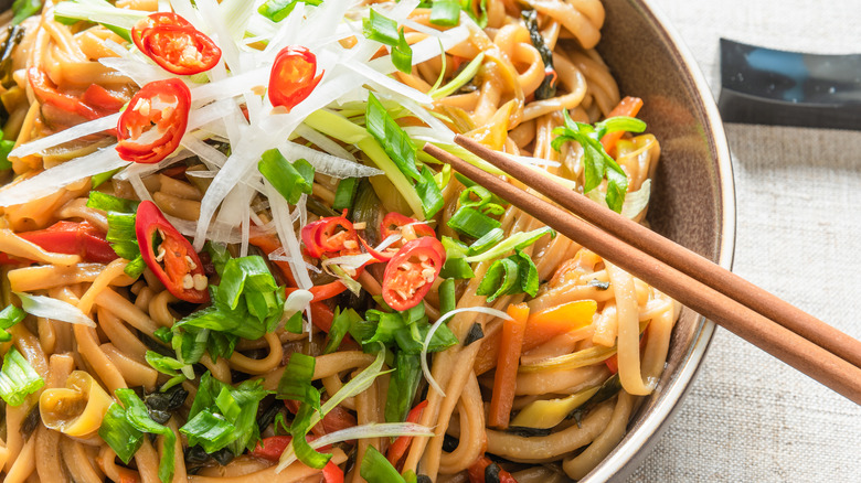 Vegetable lo mein with chopsticks