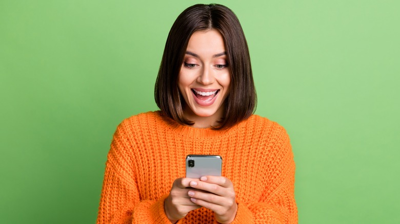 lady excited about something on phone