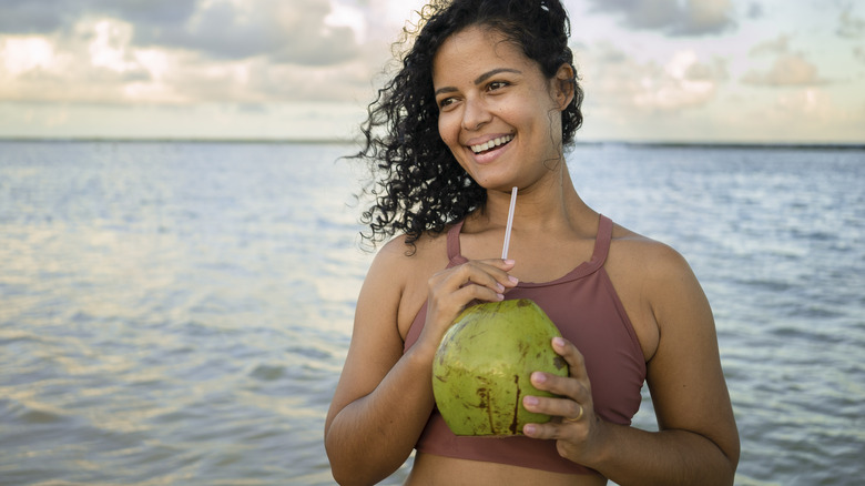 Woman drinking coconut water