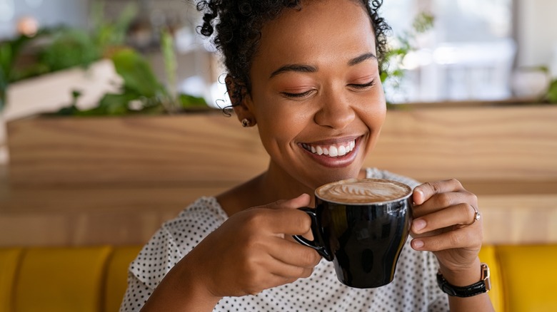 Smiling woman drinking coffee 