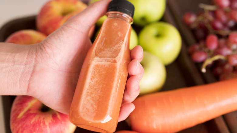 Person holding bottle of cold-pressed juice