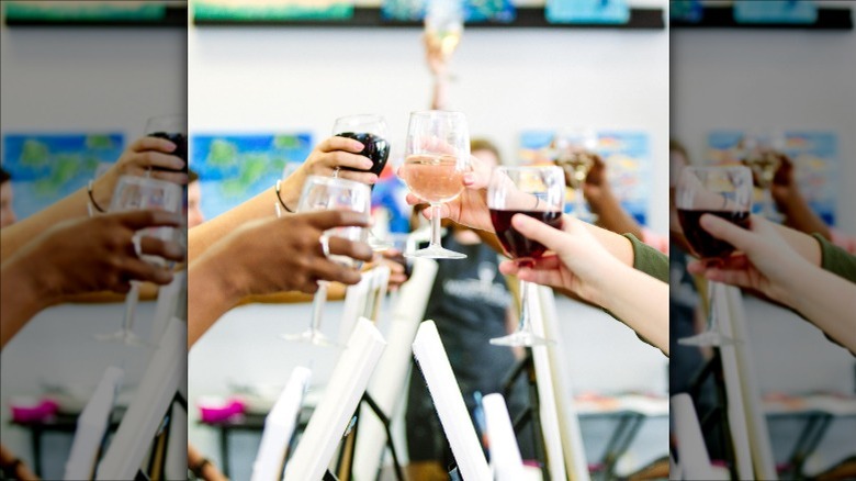 toasting wine glasses at craft studio