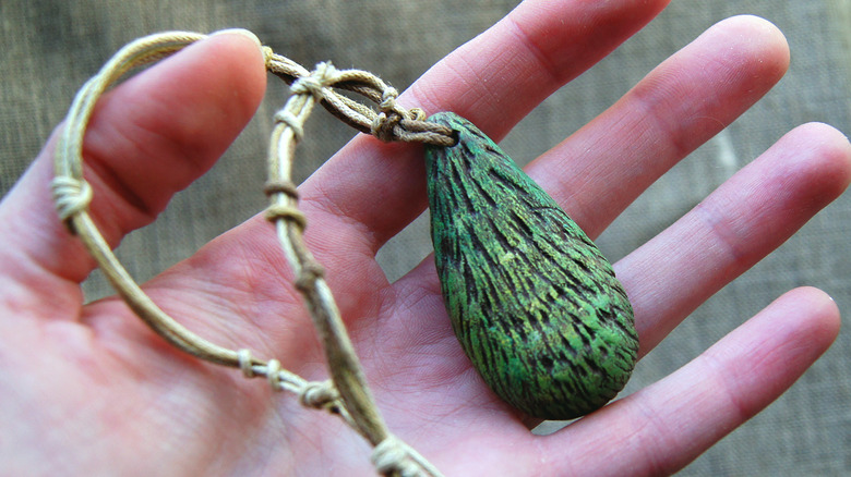 hand holding avocado necklace