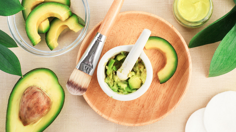 preparing avocado face mask