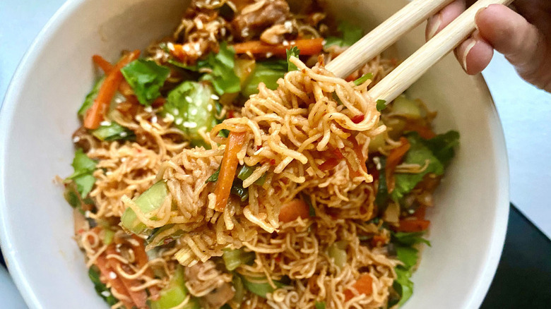 bowl of spicy noodles with chopsticks