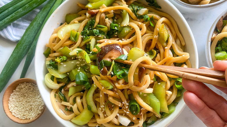 bowl of udon noodles with chopsticks