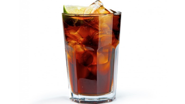 Whisky and cola with lime wedge