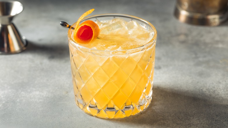 Whisky sour with orange peel garnish