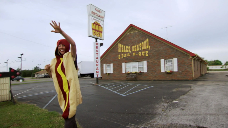 Woman in a hot dog costume outside of a steak restaurant