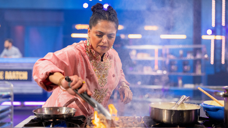 chef picking up flaming food