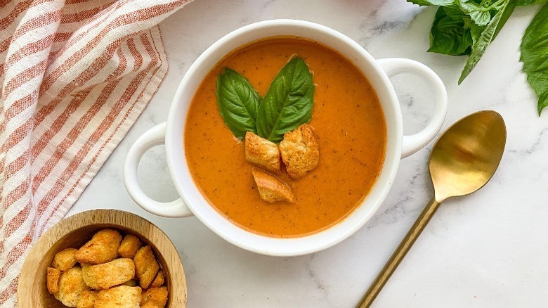 tomato bisque soup with croutons and basil