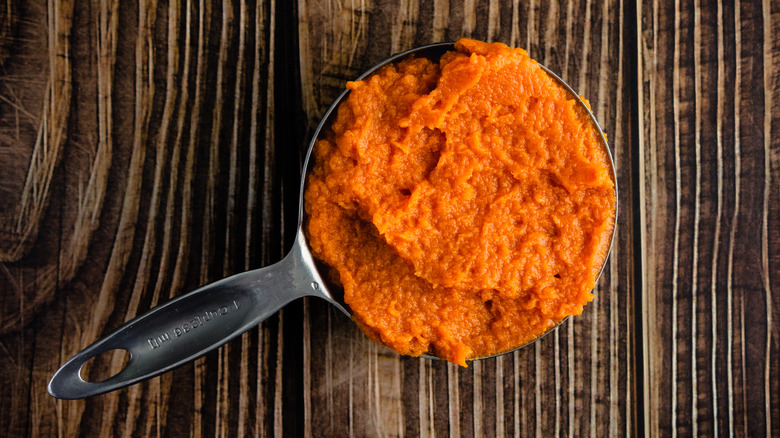 measuring cup of canned pumpkin