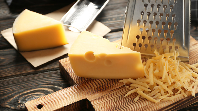 cheese with grater and grated cheese