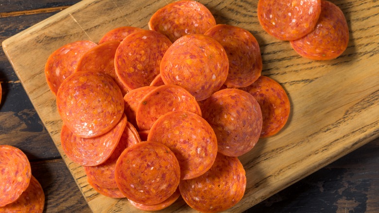 Pepperoni slices on cutting board