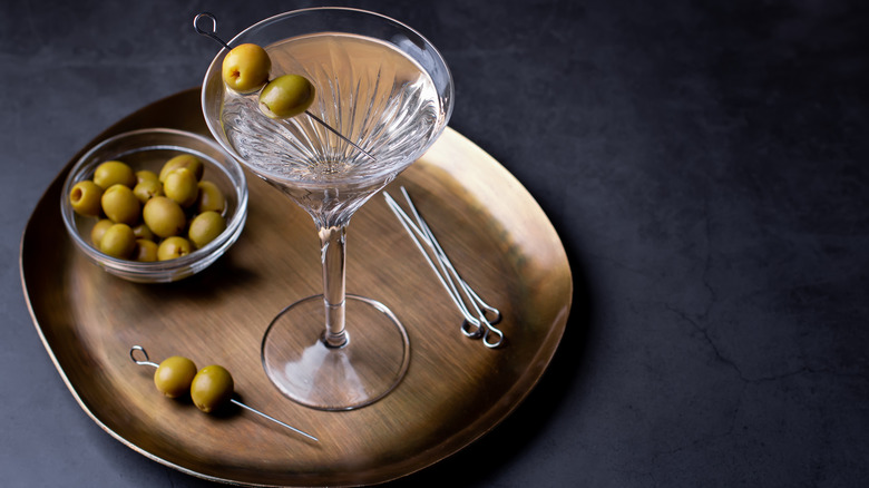 Dirty martini on wooden tray