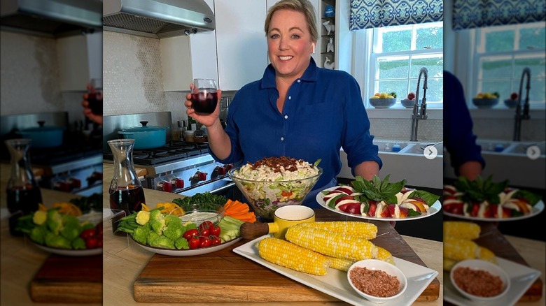 julia collin davison posing with meal at kitchen counter