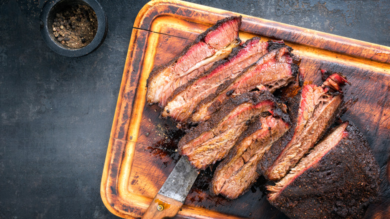 Sliced smoked brisket on a cutting board