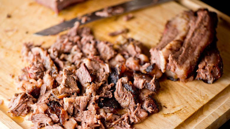 Chopped brisket with knife on cutting board