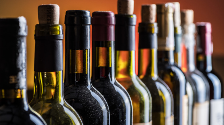 Bottles of wine against an orange background