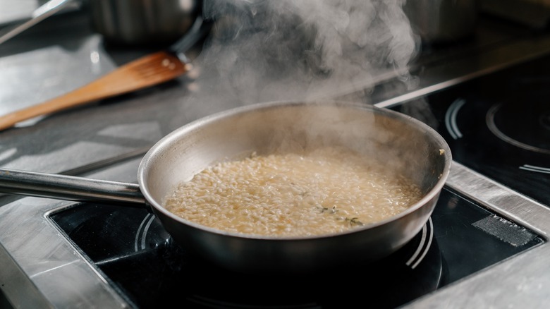 Steaming pan of risotto on a stovetop