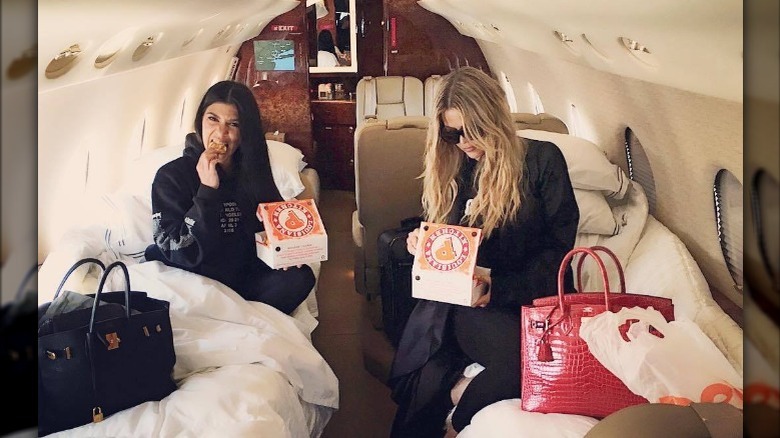 Khloe and Kourtney Kardashian eating Popeyes