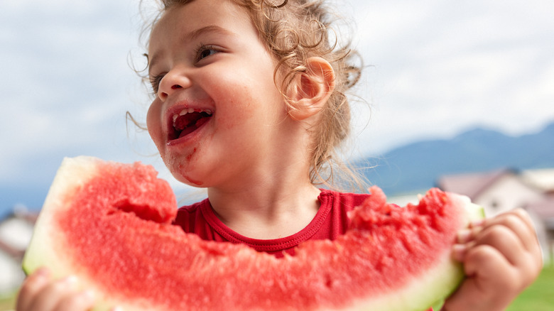 Little girl eating watermelon