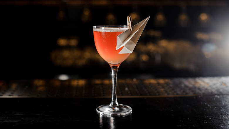 Paper plane cocktail with garnish