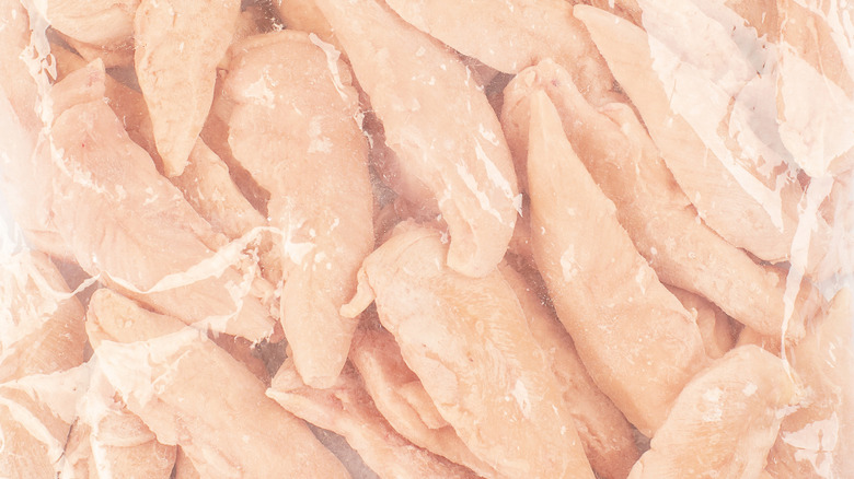 Frozen chicken pieces in plastic