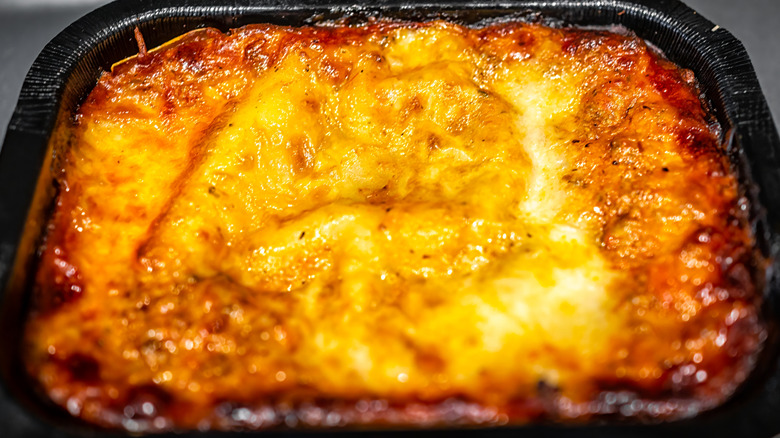 Frozen lasagna in black container