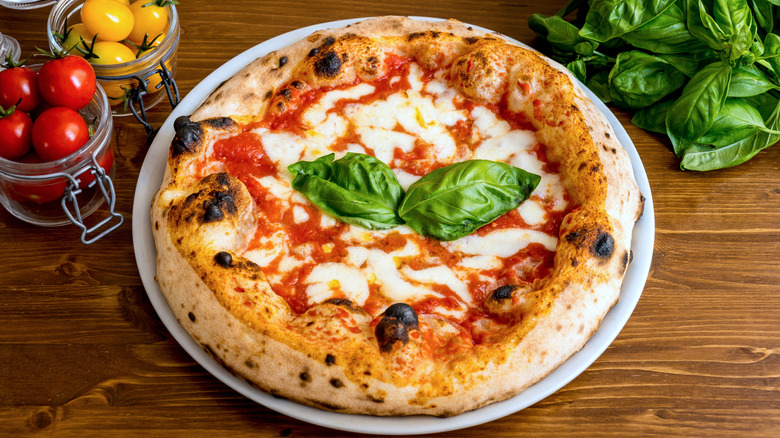 Fresh basil leaves on cooked pizza