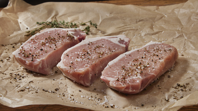 Raw meat covered in salt and pepper