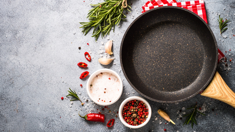 Skillet surrounded by seasonings