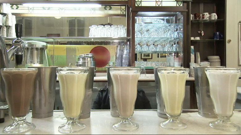 five milkshakes with glasses