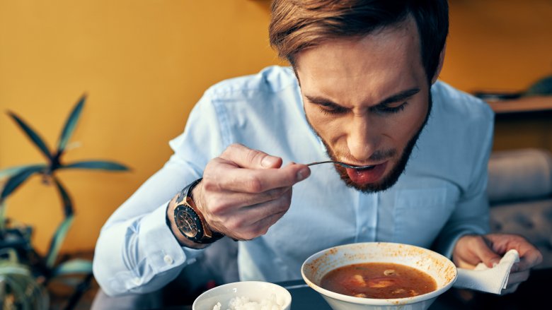 Man slurping soup