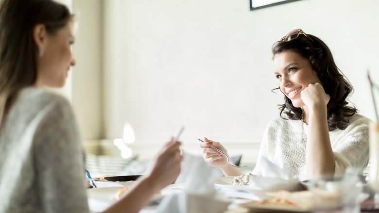 Woman with elbows on table