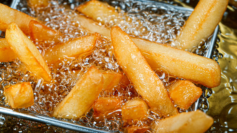 French fries in hot bubbling oil