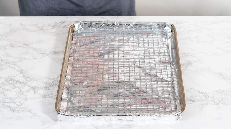 Rack on baking sheet with foil between them