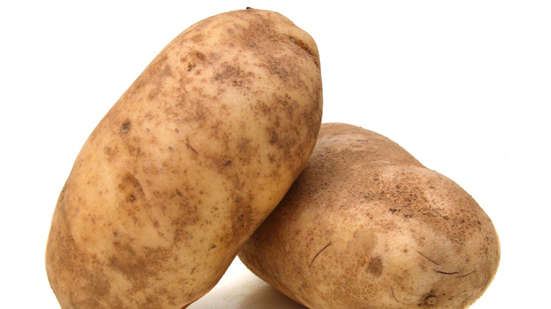 Two stacked russet potatoes