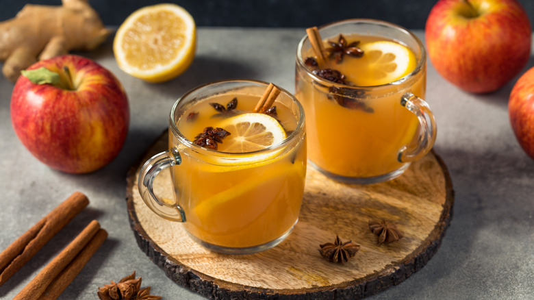 mugs of mulled cider with fruit and spices