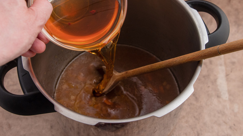 apple cider being poured into pot