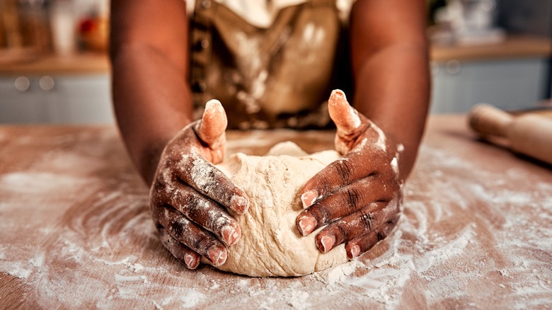 hands working with flour and dough