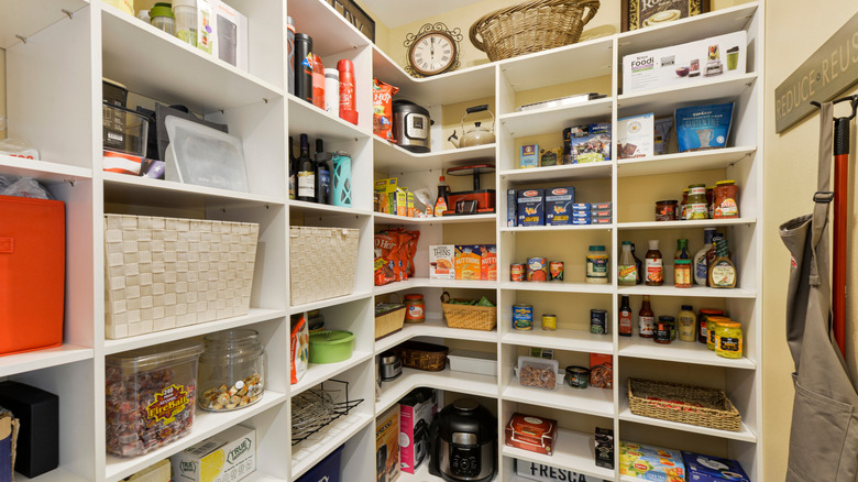 Open kitchen pantry with dry goods on shelves